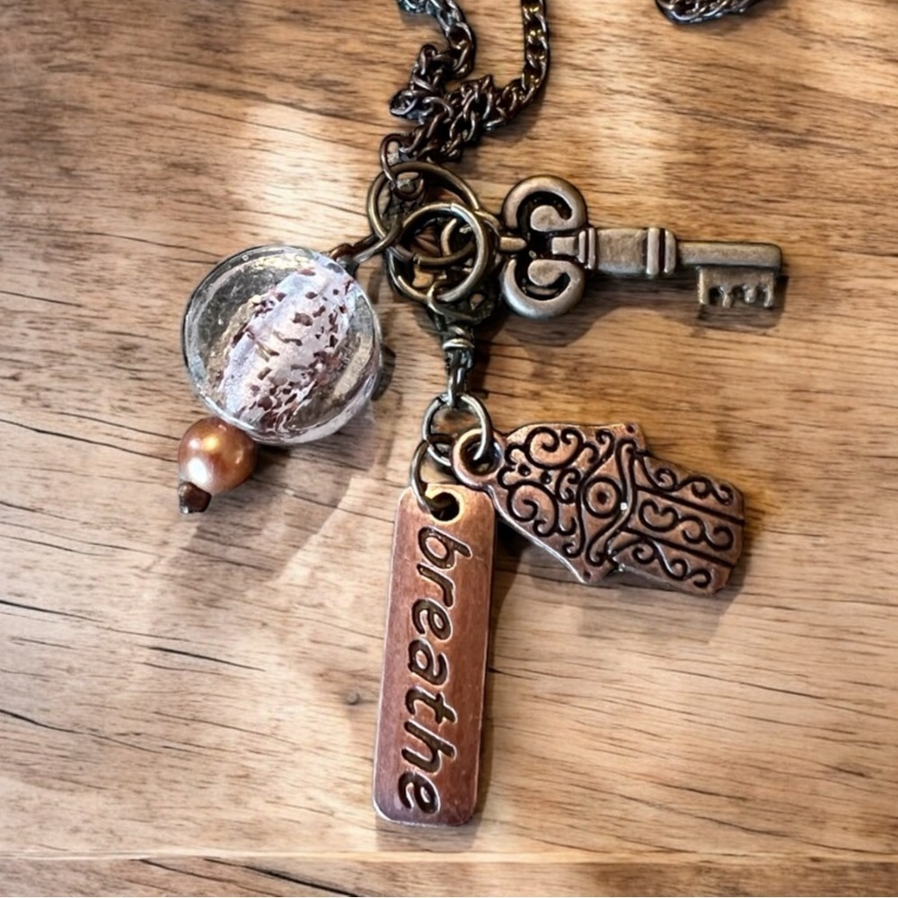 Unique bronze necklace key and charm details clear glass bead and 'breathe' tag. - Picture 14 of 15